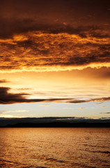 Fototapeta premium sunset over lake - golden color - Balaton, summer, apocalyptic smoke on the sky