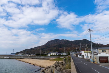 Fototapeta na wymiar A village-vicinity mountain and blue sky in shonai peninsula,kagawa,shikoku,japan