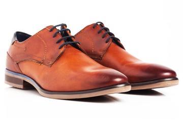 Brown shiny new Oxford shoes isolated on white background.