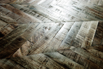 Vintage wooden parquet background. Top view of wooden texture. Herringbone, chevron flooring pattern. 