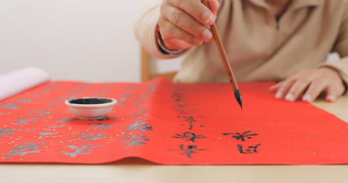 Asian Man wiring Chinese calligraphy