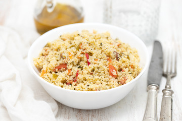 tabbouleh in white bowl on wooden background