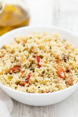 tabbouleh in white bowl on wooden background