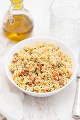 tabbouleh in white bowl on wooden background