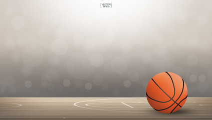 Obraz premium Basketball ball on basketball court area with light blurred bokeh background. Abstract background for basketball sport with light effect. Vector.