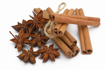 Cinnamon sticks and cardamom on a white background. Aromatic spices.