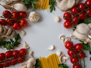 Fresh vegetables on a white background. Pasta products.
