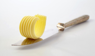 Stylish curl of chilled butter on a butter knife