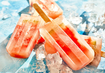 Tasty frozen melon popsicles on crushed ice