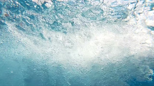  Professional video of blue underwater bubbles rising to surface in slow motion 250fps