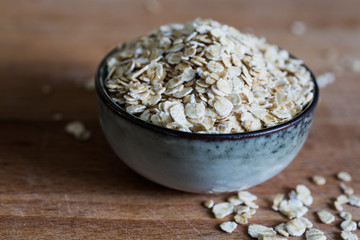 fibre source organic oat flakes for whole food diet on wooden table