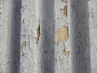 Crack gray paint on grooved wall