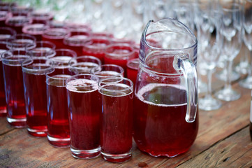 Catering for the wedding Banquet. Many glasses of water and red berry juice.