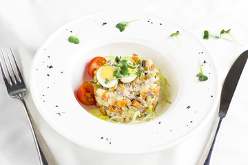 Russian Olivier salad with meat, quail eggs and cherry tomatoes