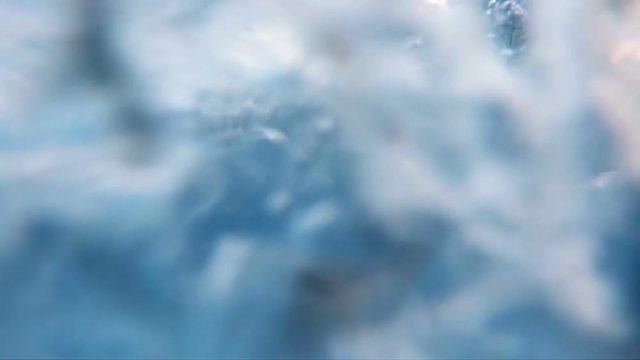 Professional video of blue underwater bubbles rising to surface in slow motion 250fps