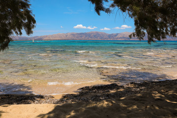 Sandy beach with aquamarine sea water in Elafonisos village island, Laconia, Peloponnese, Greece, June 2018.