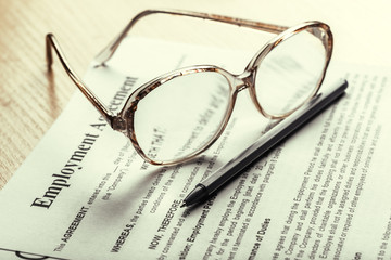 Close up shot of Eyeglasses  on contract document papers business concept