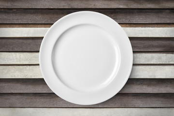 Empty plate on old wooden background. Top view