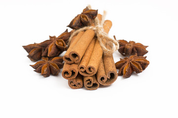 Cinnamon sticks and cardamom on a white background. Aromatic spices.