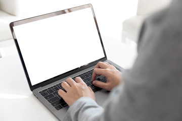 Women using laptop with blank screen at table in the office