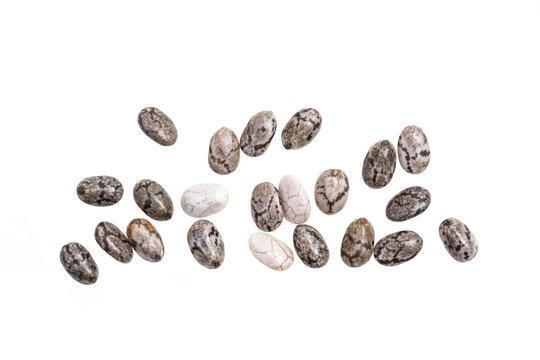 Close up of some healthy chia seeds spread out and isolated on white background