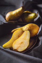 close-up shot of sliced ripe pears on grey drapery