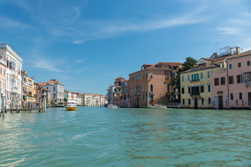Gondola passing by multicolored buildings