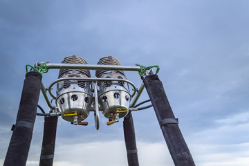 Balloon gas burners against blue cloudy sky.