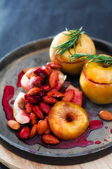 Baked sweet yellow apple with nuts and  berry in sugar glaze