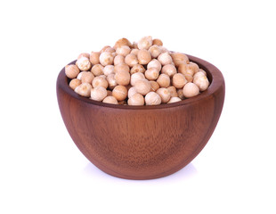 Dried chickpeas in wooden bowl on white background.