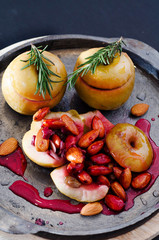 Baked sweet yellow apple with nuts and  berry in sugar glaze