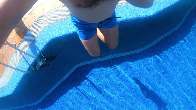 Professional video of man jumping into the pool in slow motion 250fps