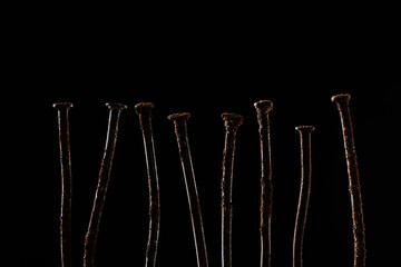 close up view of vintage rusty nails isolated on black