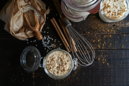Glass jars with served rice and milk