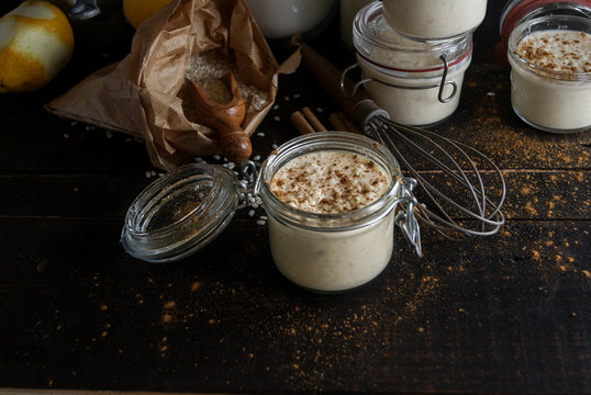 Glass jars with served rice and milk