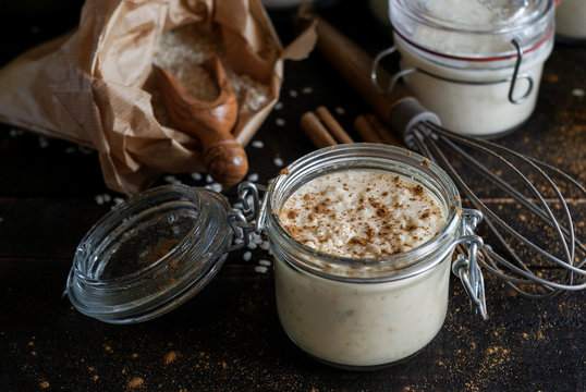 Glass jars with served rice and milk