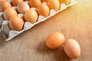 Fresh chicken eggs eggs in paper tray,egg carton on wooden background.