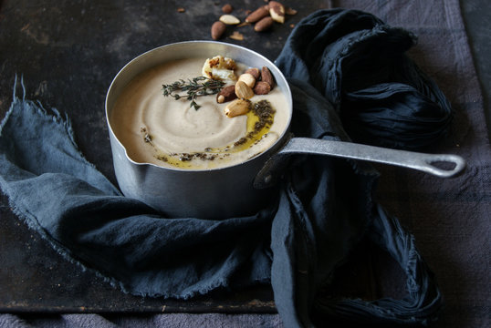 Close up of creamy cauliflower soup garnish with almonds