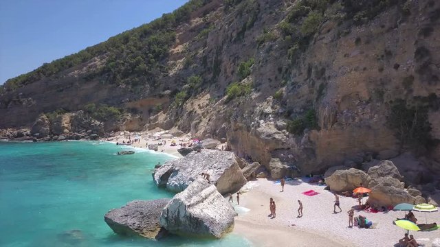 Cala Luna Sardinia aerial view on mediterranean coast - people on the beach