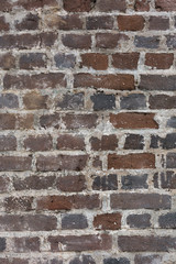 Old red rustic stone bricks wall vertical pattern texture background