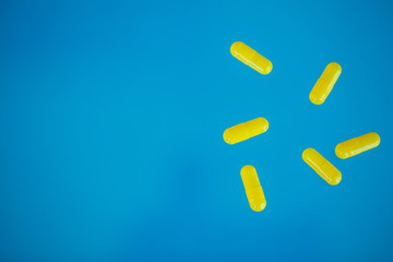 Medical Pills. Colored Pills And Capsule On Blue Background. Pharmacy Theme, Capsule Pills With Medicine Antibiotic in Packages