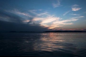 sunset at Balaton lake - metallic color, tiny waves, hills in background