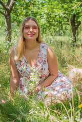 Naklejka na ściany i meble Plus size European or American sweet woman at nature, enjoy the life, walks. Life of people xl size, happy nice natural beauty woman. Concept of overweight 