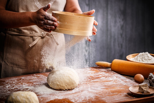Woman hands sifting flour
