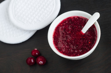 Homemade cranberry face mask (scrub) in a small white bowl. Diy cosmetics.  