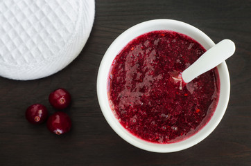 Homemade cranberry face mask (scrub) in a small white bowl. Diy cosmetics.  