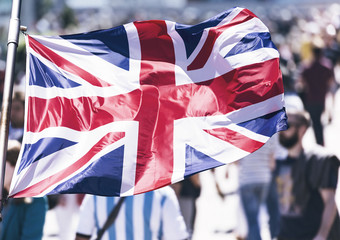  Crowd of People as Background and British Flag