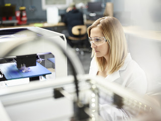 Female technician checking D printer