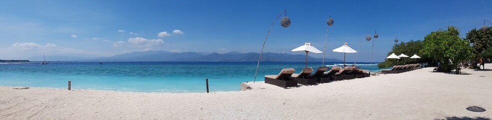 Tropical beach chair bench and umbrella paradise with white sand. Panorama holiday travel background banner