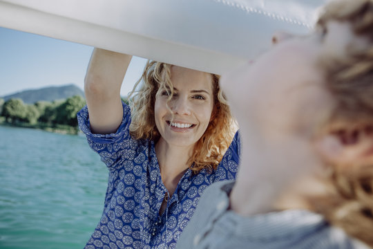 Smiling mother looking at son on a sailing boat